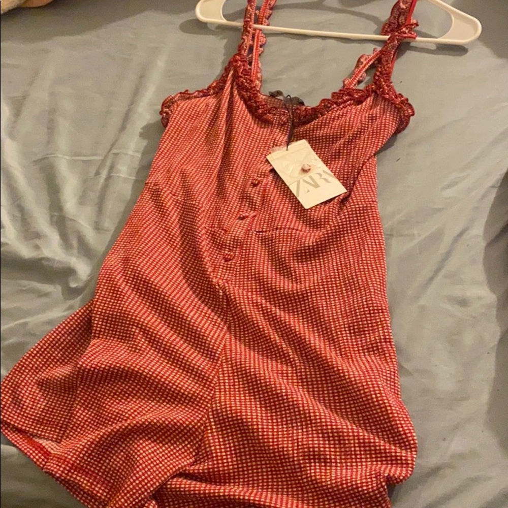 A red and white polka dot romper